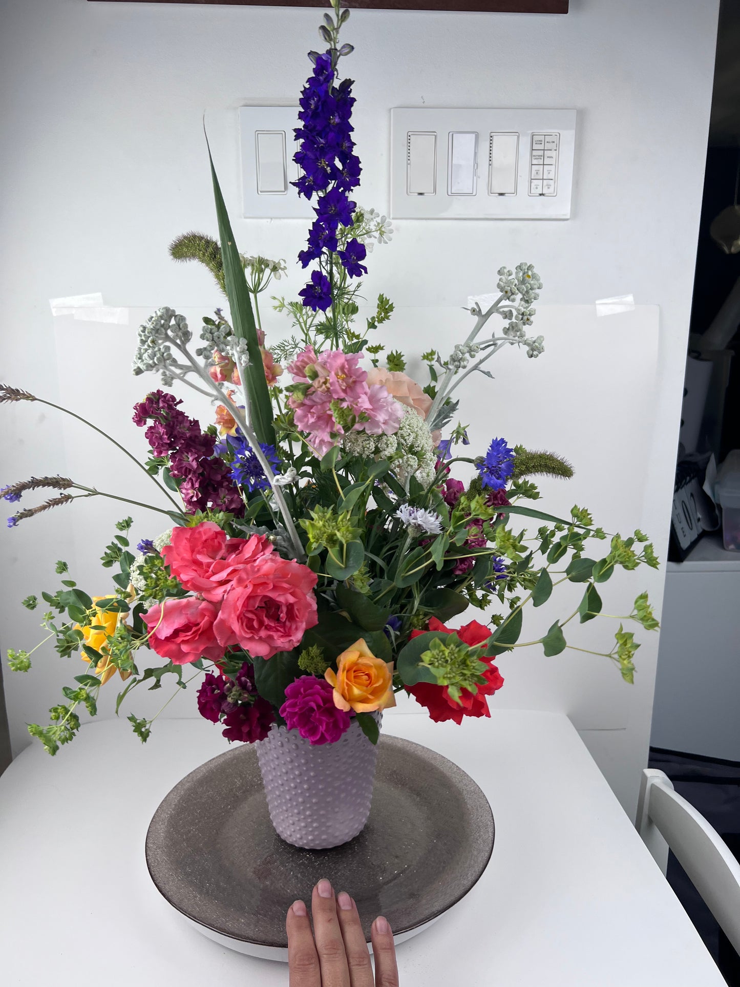 an example of an "extra" sized bouquet with roses, larkspur, bachelor buttons, bupleurum, stock, dusty miller, carrot flower